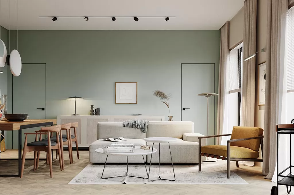 Мінімалістичний інтер’єр з бежевим диваном, м’яким зеленим фоном стін і світлими дерев’яними меблями